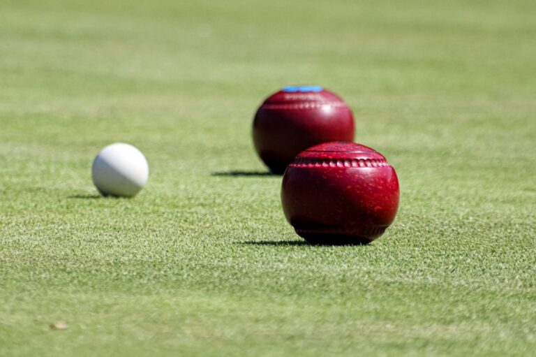 Lawn bowling bowls and a jack ball on the grass on a bowling green