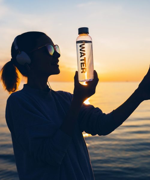 woman-at-sea-holding-bottle-of-water-2021-08-30-16-39-41-utc-scaled.jpg